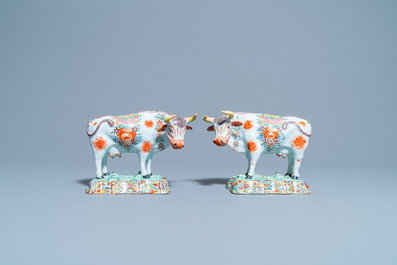 A pair of polychrome petit feu and gilded Dutch Delft models of cows, 1st half 18th C.