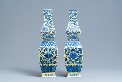 A pair of Chinese blue and white yellow-ground vases, 19th C.