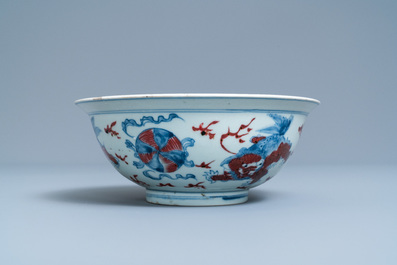 A Chinese blue, white and copper red bowl with Buddhist lions, Qianlong mark, 19th C.