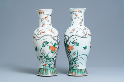 A pair of Chinese famille verte vases with birds among blossoming branches, 19th C.