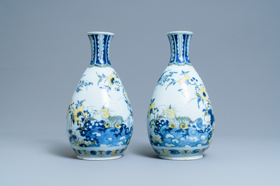A pair of unusual polychrome Dutch Delft chinoiserie vases with a dragon and birds in a flowery garden, 17th C.