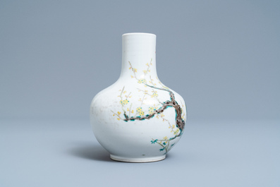 A Chinese famille rose bottle vase with peacocks, Qianlong mark, 19th C.