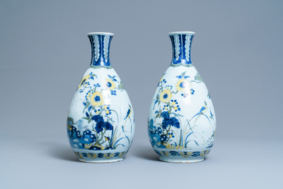 A pair of unusual polychrome Dutch Delft chinoiserie vases with a dragon and birds in a flowery garden, 17th C.