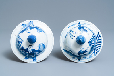 A pair of Chinese blue and white vases and covers with figures in a landscape, 19th C.