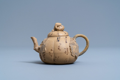 A bichrome Chinese Yixing stoneware teapot and cover with applied floral design, 19th C.