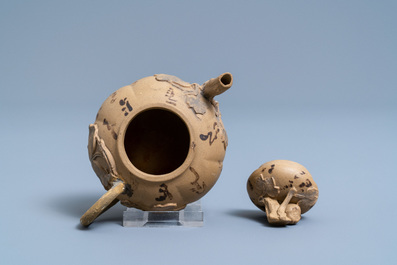 A bichrome Chinese Yixing stoneware teapot and cover with applied floral design, 19th C.