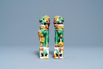 A pair of Chinese sancai-glazed biscuit Buddhist lion joss stick holders, Kangxi