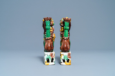 A pair of Chinese sancai-glazed biscuit Buddhist lion joss stick holders, Kangxi