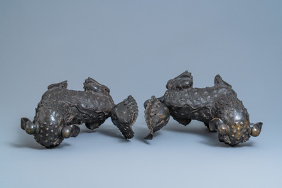 A pair of large Chinese bronze models of Buddhist lions, Ming