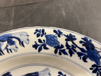 Een Chinese blauw-witte schotel met dames bij een jardini&egrave;re, Kangxi