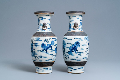 A pair of Chinese blue and white Nanking crackle-glazed vases with Buddhist lions, 19th C.