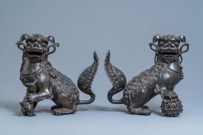 A pair of large Chinese bronze models of Buddhist lions, Ming