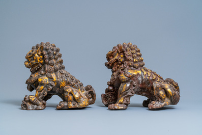 A pair of large Chinese gilt-lacquered iron models of Buddhist lions, 18/19th C.