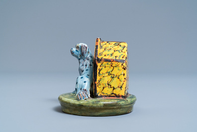 A polychrome Dutch Delft model of a dog by its doghouse, 18th C.