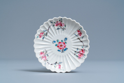 A lobed Chinese famille rose cup and saucer with floral design, Yongzheng