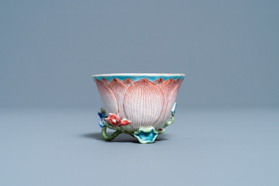 A Chinese famille rose 'lotus' cup and saucer with applied design, Yongzheng