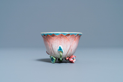 A Chinese famille rose 'lotus' cup and saucer with applied design, Yongzheng