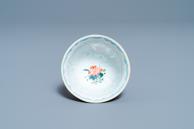 A Chinese famille rose 'lotus' cup and saucer with applied design, Yongzheng