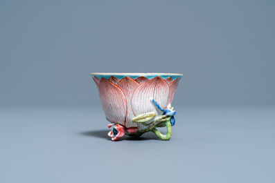 A Chinese famille rose 'lotus' cup and saucer with applied design, Yongzheng