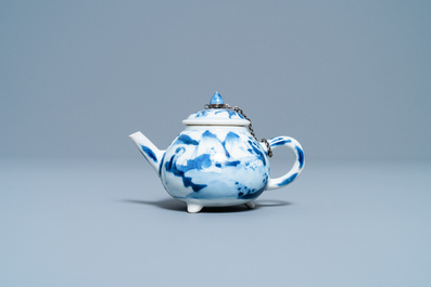 A Chinese blue and white tripod teapot with figures in a landscape, Kangxi