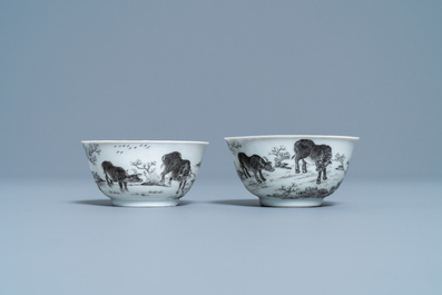 A pair of Chinese grisaille and gilt 'buffalo' cups and saucers, Yongzheng