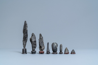 Eight Chinese scholar's rocks on wooden stands, 19/20th C.