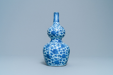 A Chinese blue and white 'lotus scroll' double gourd vase, Wanli