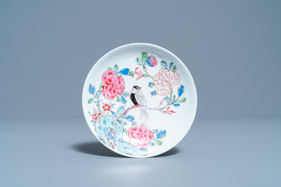 A Chinese famille rose cup and saucer with a bird on a blossoming branch, Yongzheng