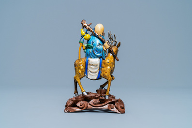 A Chinese enamelled silver figure of Shou Lao on a deer, 19th C.