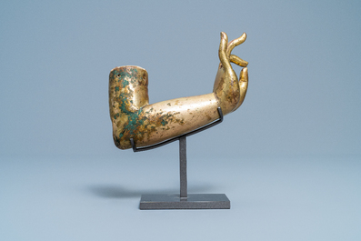 A Tibetan gilt bronze and copper alloy arm of Buddha, Ming