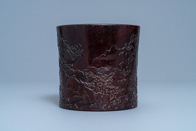 A Chinese carved zitan wood brush pot with a mountainous landscape, 17/18th C.