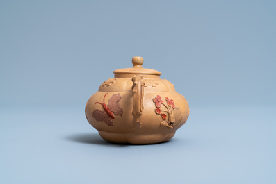 A bichrome Chinese Yixing stoneware teapot and cover with applied design, Kangxi