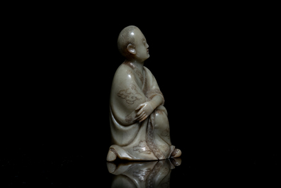 A Chinese Shoushan soapstone figure of a seated man, 18/19th C.