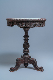 A Chinese carved wooden table with a large Canton famille verte plaque, 19th C.