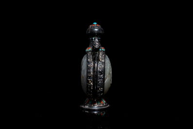 A Chinese jade-, coral- and turquoise-inlaid silver snuff bottle, 19th C.