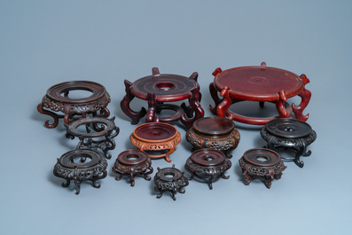 Twelve large round Chinese carved wooden stands, 19/20th C.