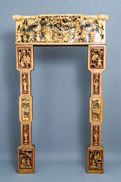 A Chinese gilded wood carving on matching pillars, 19th C.