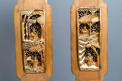 A Chinese gilded wood carving on matching pillars, 19th C.