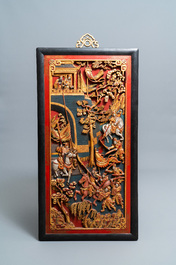 A Chinese lacquered and polychromed carved wooden panel, 19th C.