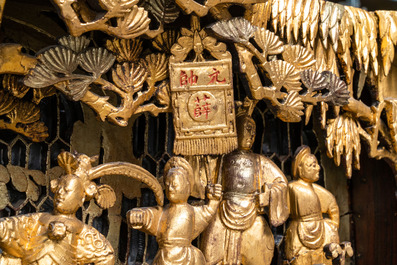 A Chinese gilded wood carving on matching pillars, 19th C.