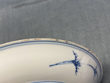 A Chinese blue, white and copper red saucer dish with floral design, Kangxi