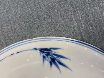 A Chinese blue, white and copper red saucer dish with floral design, Kangxi