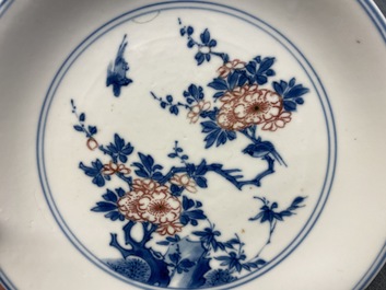 A Chinese blue, white and copper red saucer dish with floral design, Kangxi