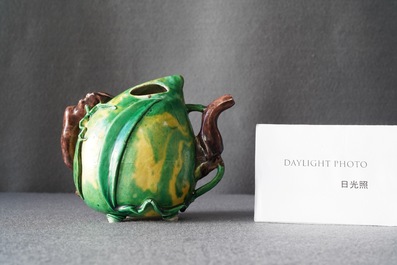 A Chinese verte biscuit peach-shaped 'cadogan' teapot, Kangxi