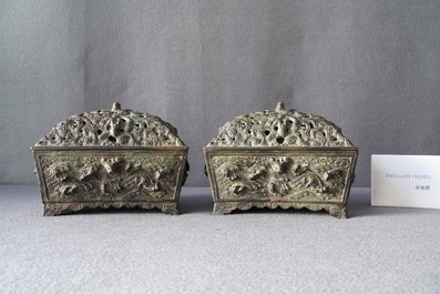 A pair of Chinese Ming-style bronze censers with reticulated covers, 19th C.