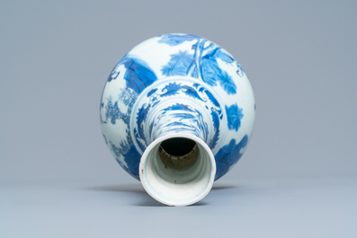 A Chinese blue and white bottle vase with figures in a landscape, Transitional period