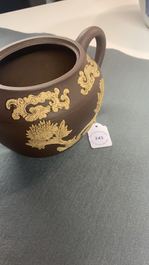 A bichrome Chinese Yixing stoneware teapot and cover with applied floral design, Kangxi