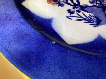 Un plat en porcelaine de Chine en bleu, blanc et rouge de cuivre sur fond bleu poudr&eacute;, Kangxi