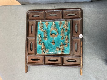 A Chinese square fahua 'Immortals' plaque mounted in a wooden table screen, Ming