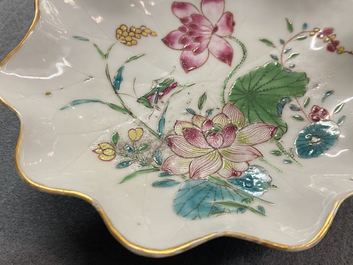 A Chinese famille rose 'lotus' cup and saucer with applied design, Yongzheng